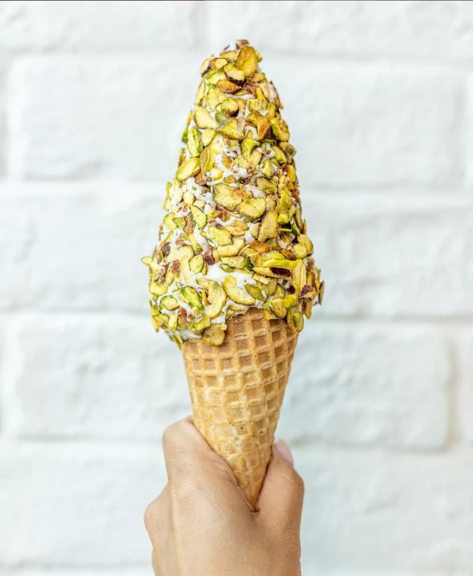 Bachir pistachio ice cream cone held in hand